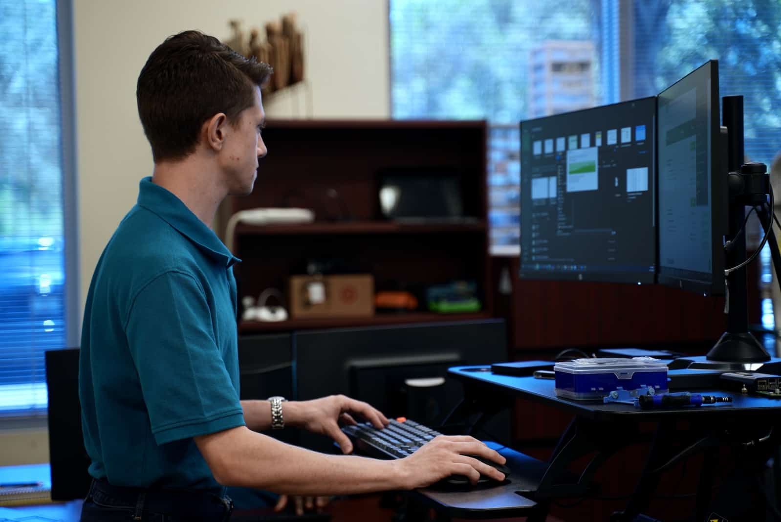 Blue Light IT team member working on computer monitors