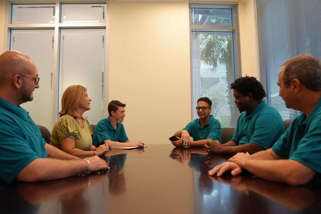 The Blue Light IT team discussing cybersecurity & managed IT at the meeting table.