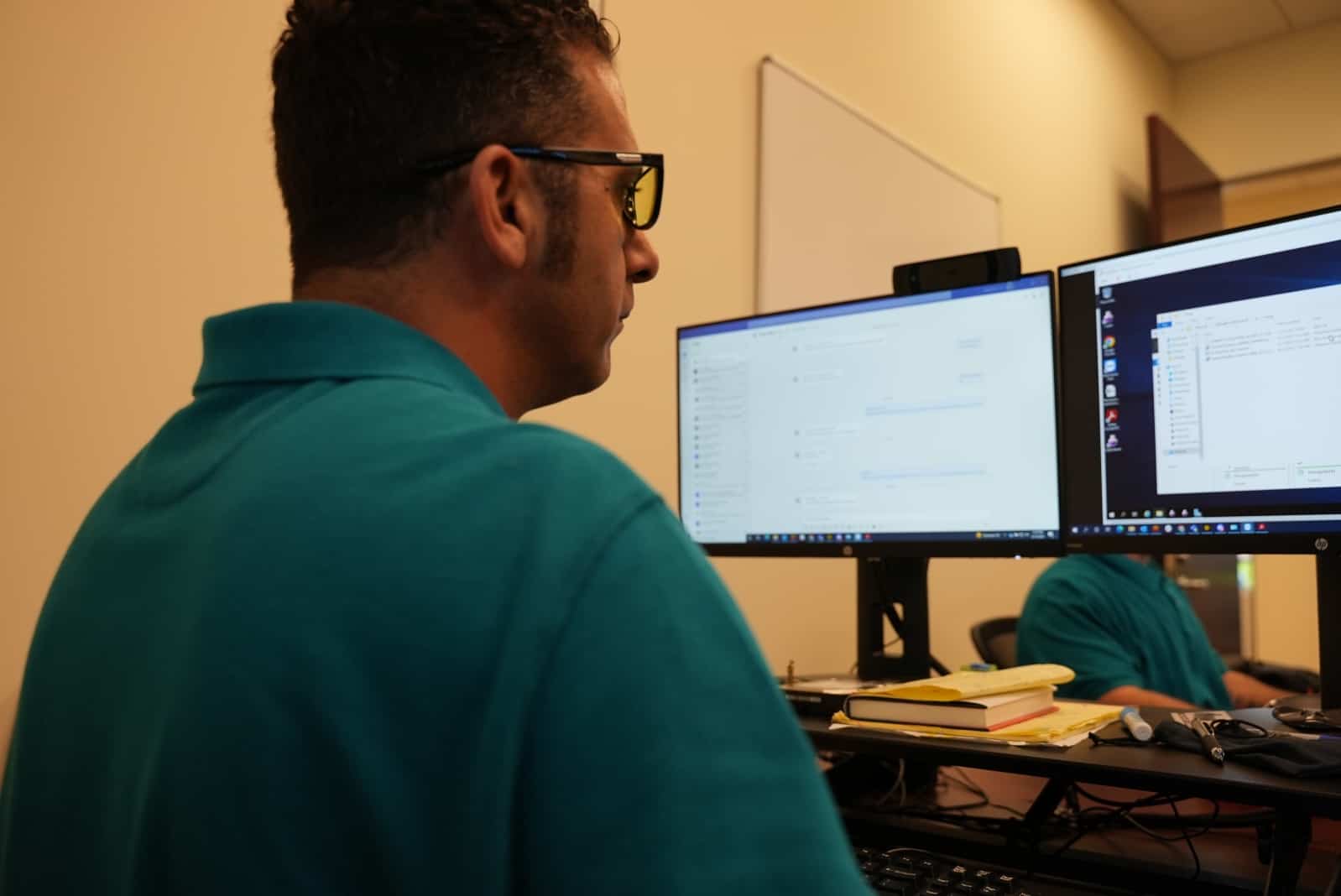 A Blue Light IT team member looking at monitors looking at cloud computing options for a client.