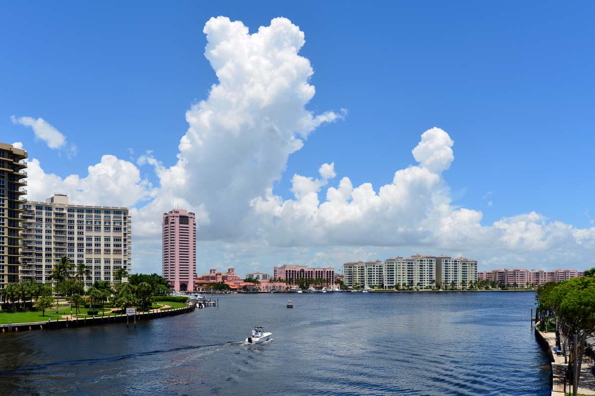 View of Boca Raton, Florida city skyline against a beautiful partly cloudy blue sky.
