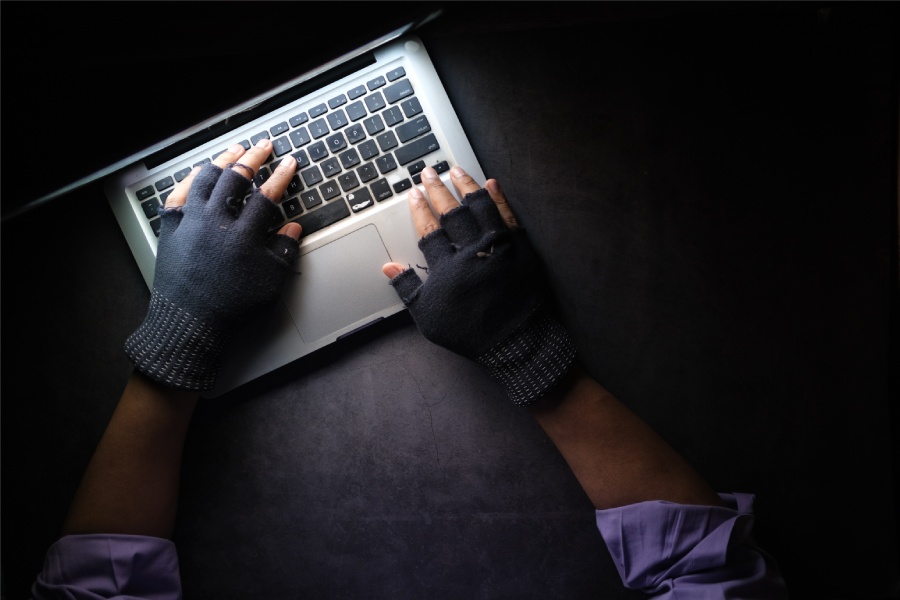 a cybercriminal working on damaging a companies reputation