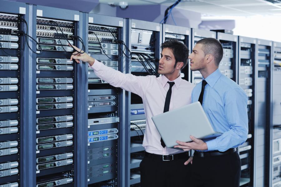 Two technicians in a server room providing Managed IT Support services for a business in Boca Raton.